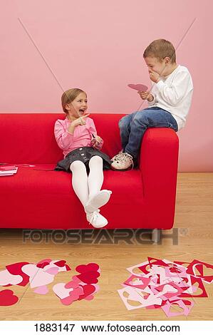 A Boy And Girl Cutting Out Various Colored Hearts And Being Silly Together View Large Photo Image Stock Photo - A Boy And Girl Cutting Out Various Colored Hearts And Being Silly Together. Fotosearch