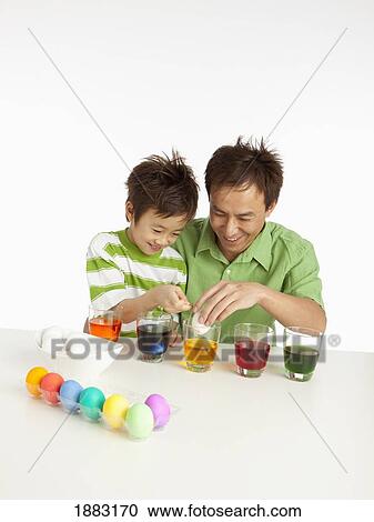 A Boy And His Father Dying Easter Eggs View Large Photo Image Stock Image - A Boy And His Father Dying Easter Eggs. Fotosearch