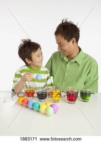 A Boy And His Father Dying Easter Eggs View Large Photo Image Stock Image - A Boy And His Father Dying Easter Eggs. Fotosearch