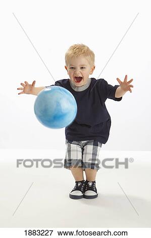 Stock Photo - A Boy Bouncing A Ball. Fotosearch