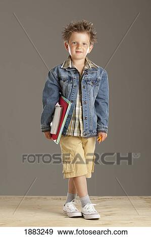 A Boy Holding His Notebooks And Pencils View Large Photo Image Stock Photo - A Boy Holding His Notebooks And Pencils. Fotosearch
