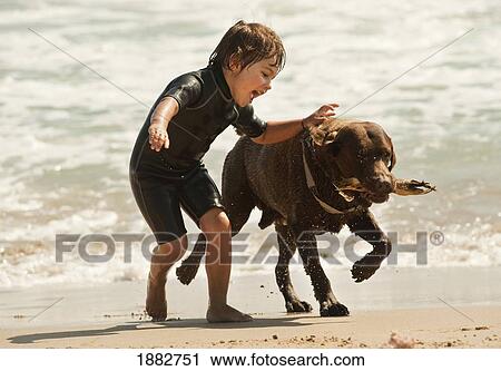A Boy Runs With A Dog On Dos Mares Beach In Front Of Hotel Dos Mares; Tarifa, Cadiz, Andalusia, Spain View Large Photo Image Stock Image - A Boy Runs With A Dog On Dos Mares Beach In Front Of Hotel Dos Mares; Tarifa, Cadiz, Andalusia, Spain. Fotosearch