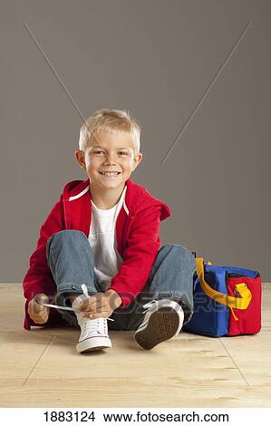 A Boy Tying A Bow With A Shoelace View Large Photo Image Picture - A Boy Tying A Bow With A Shoelace. Fotosearch