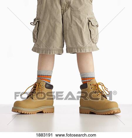 A Boy Wearing Work Boots View Large Photo Image Stock Image - A Boy Wearing Work Boots. Fotosearch
