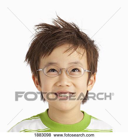 Stock Photo - A Boy With Glasses And Styled Hair. Fotosearch