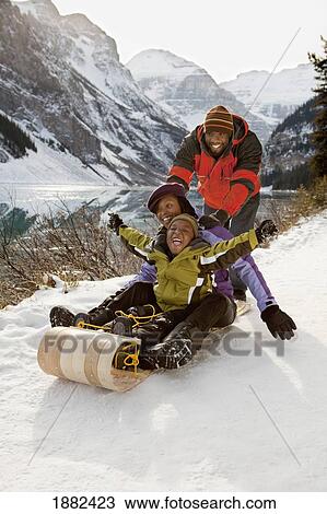 A Family Rides A Toboggan; Lake Louise, Alberta, Canada View Large Photo Image Stock Image - A Family Rides A Toboggan; Lake Louise, Alberta, Canada. Fotosearch