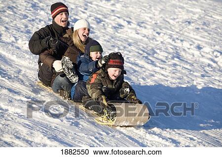 A Family Riding A Toboggan Down A Hill; Edmonton, Alberta, Canada View Large Photo Image Stock Image - A Family Riding A Toboggan Down A Hill; Edmonton, Alberta, Canada. Fotosearch