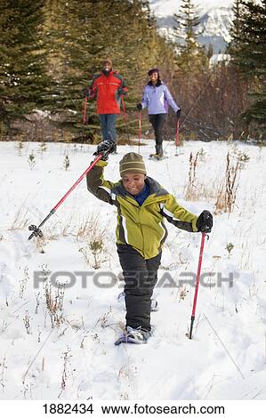 A Family Skiing In The Mountains; Lake Louise, Alberta, Canada View Large Photo Image Picture - A Family Skiing In The Mountains; Lake Louise, Alberta, Canada. Fotosearch