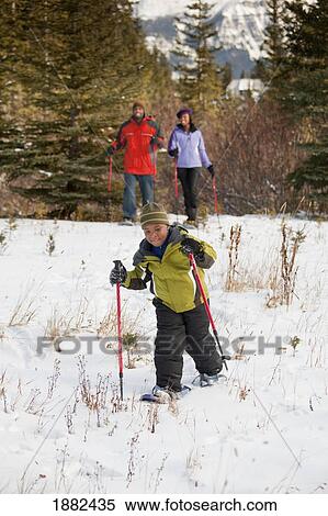 A Family Skiing In The Mountains; Lake Louise, Alberta, Canada View Large Photo Image Stock Photography - A Family Skiing In The Mountains; Lake Louise, Alberta, Canada. Fotosearch