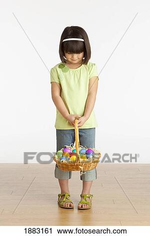 A Girl Holding A Basket Of Easter Eggs View Large Photo Image Stock Image - A Girl Holding A Basket Of Easter Eggs. Fotosearch