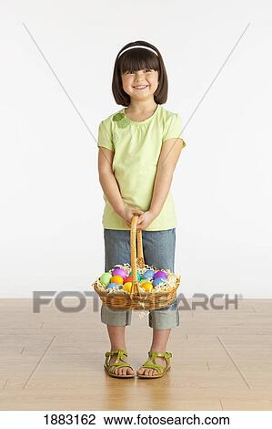 A Girl Holding A Basket Of Easter Eggs View Large Photo Image Stock Image - A Girl Holding A Basket Of Easter Eggs. Fotosearch