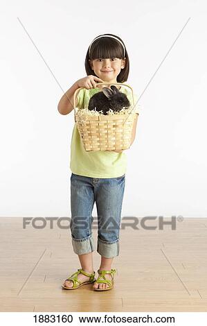 A Girl Holding A Basket With A Rabbit In It View Large Photo Image Stock Image - A Girl Holding A Basket With A Rabbit In It. Fotosearch