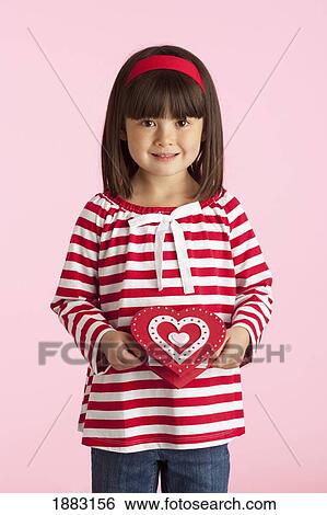 A Girl Holding A Heart Shaped Box View Large Photo Image Stock Photograph - A Girl Holding A Heart Shaped Box. Fotosearch