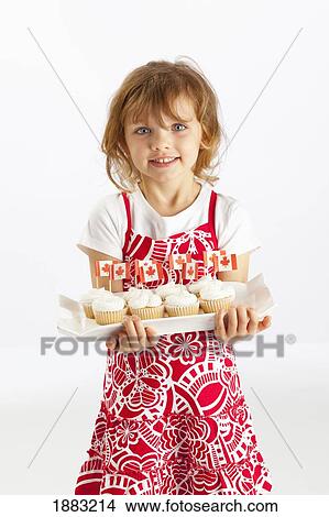 A Girl Holding A Plate Of Cupcakes View Large Photo Image Picture - A Girl Holding A Plate Of Cupcakes. Fotosearch
