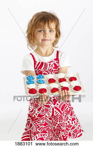 Stock Image - A Girl Holding A Platter Of Cupcakes. Fotosearch