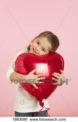 A Girl Holding A Red Heart Shaped Balloon View Large Photo Image Stock Image - A Girl Holding A Red Heart Shaped Balloon. Fotosearch