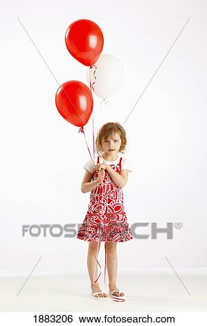 A Girl Holding Two Red Balloons View Large Photo Image Stock Photograph - A Girl Holding Two Red Balloons. Fotosearch
