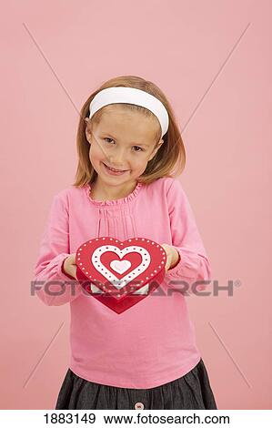 A Girl Holds A Heart Shaped Box View Large Photo Image Stock Photo - A Girl Holds A Heart Shaped Box. Fotosearch