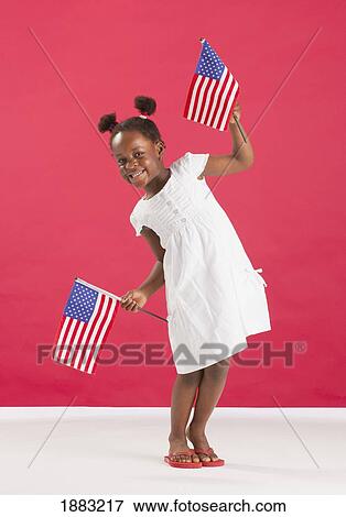 A Girl Holds Two American Flags View Large Photo Image Stock Photo - A Girl Holds Two American Flags. Fotosearch