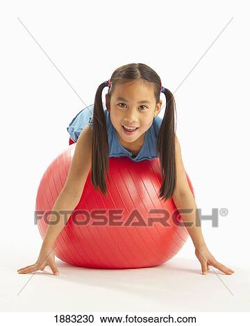 A Girl Laying On A Large Red Exercise Ball View Large Photo Image Stock Image - A Girl Laying On A Large Red Exercise Ball. Fotosearch