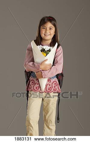 A Girl With A Backpack Holding A Bouquet Of Flowers View Large Photo Image Stock Image - A Girl With A Backpack Holding A Bouquet Of Flowers. Fotosearch