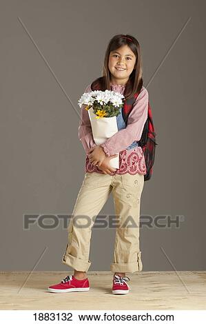 A Girl With A Backpack Holding A Bouquet Of Flowers View Large Photo Image Stock Image - A Girl With A Backpack Holding A Bouquet Of Flowers. Fotosearch