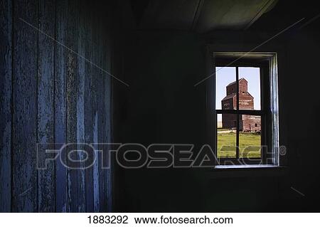 A Grain Elevator Seen Through The Window Of An Old, Abandoned Ghost Town Store; Bents, Saskatchewan, Canada View Large Photo Image Stock Image - A Grain Elevator Seen Through The Window Of An Old, Abandoned Ghost Town Store; Bents, Saskatchewan, Canada. Fotosearch