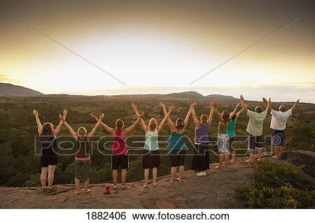 A Group Of People In A Row With Arms Raised To The Sky; Manica, Mozambique, Africa View Large Photo Image Stock Photograph - A Group Of People In A Row With Arms Raised To The Sky; Manica, Mozambique, Africa. Fotosearch