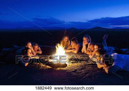 A Group Of People Laying By A Campfire; Manica, Mozambique, Africa View Large Photo Image Stock Photo - A Group Of People Laying By A Campfire; Manica, Mozambique, Africa. Fotosearch