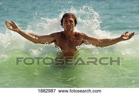 A Man Coming Up Out Of The Water At Punta Paloma Beach; Tarifa, Cadiz, Andalusia, Spain View Large Photo Image Stock Photo - A Man Coming Up Out Of The Water At Punta Paloma Beach; Tarifa, Cadiz, Andalusia, Spain. Fotosearch