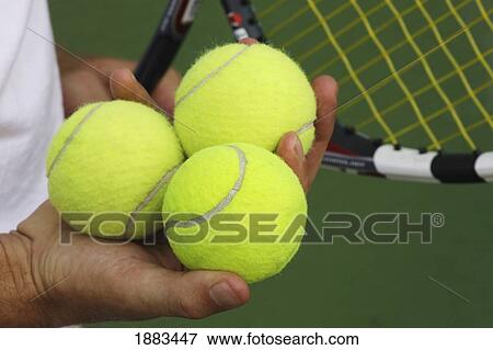 A Man On A Tennis Court Holding A Racquet And Three Tennis Balls View Large Photo Image Stock Photo - A Man On A Tennis Court Holding A Racquet And Three Tennis Balls. Fotosearch