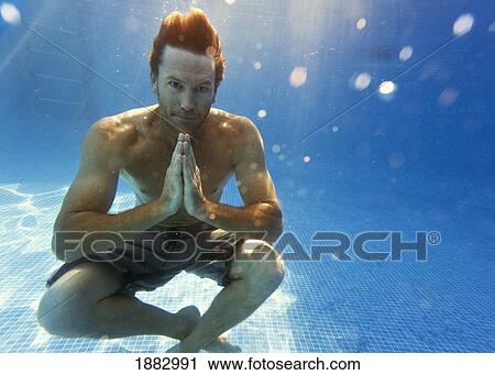 A Man Sitting Underwater In A Meditation Pose View Large Photo Image Stock Image - A Man Sitting Underwater In A Meditation Pose. Fotosearch