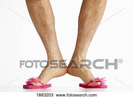 Stock Image - A Man Wearing Small Pink Flip Flops. Fotosearch