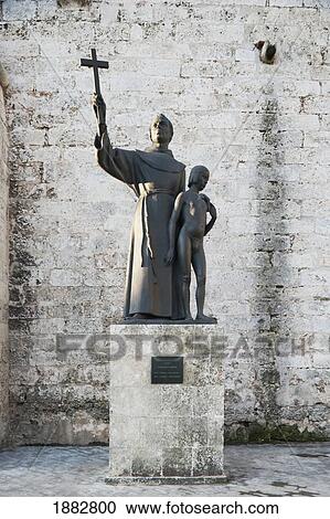 Stock Image - A Monument Of Fray Junipero Serra With Juaneño, An Indian Boy, At The Front Of The 16Th Century Basilica Menor De San Francisco De Asis In Plaza De San Francisco; Havana, Cuba. Fotosearch