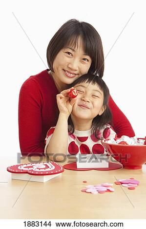 A Mother And Daughter Making Valentine's Day Crafts View Large Photo Image Picture - A Mother And Daughter Making Valentine's Day Crafts. Fotosearch