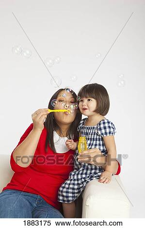 A Mother Blowing Bubbles With Her Young Daughter View Large Photo Image Stock Photography - A Mother Blowing Bubbles With Her Young Daughter. Fotosearch