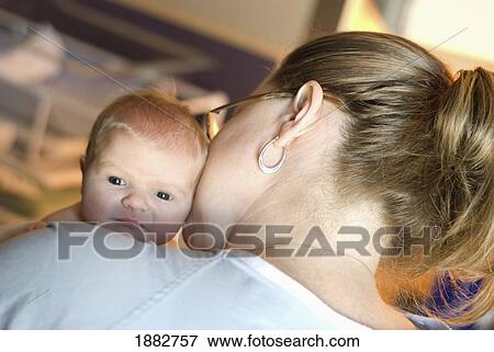 A Mother Holds And Kisses Her Newborn Baby; Millet, Alberta, Canada View Large Photo Image Stock Photo - A Mother Holds And Kisses Her Newborn Baby; Millet, Alberta, Canada. Fotosearch