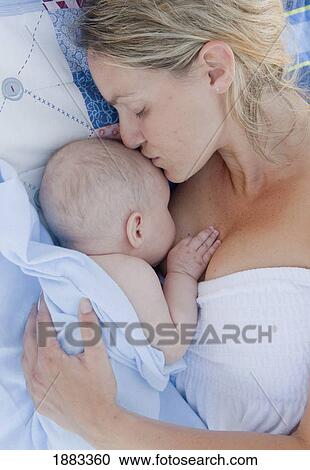 A Mother Holds Her Baby Close With A Kiss; Banalmadena Costa, Malaga, Andalusia, Spain View Large Photo Image Stock Image - A Mother Holds Her Baby Close With A Kiss; Banalmadena Costa, Malaga, Andalusia, Spain. Fotosearch