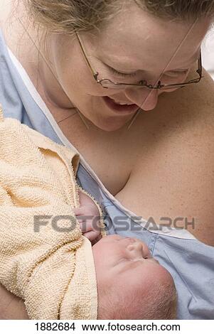 A Mother Holds Her Newborn Baby; Millet, Alberta, Canada View Large Photo Image Picture - A Mother Holds Her Newborn Baby; Millet, Alberta, Canada. Fotosearch