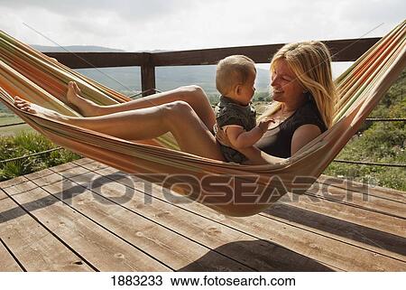 A Mother In A Hammock With Her Young Son; Tarifa, Cadiz, Andalusia, Spain View Large Photo Image Stock Image - A Mother In A Hammock With Her Young Son; Tarifa, Cadiz, Andalusia, Spain. Fotosearch
