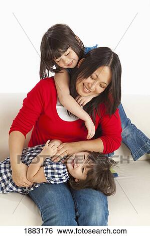 A Mother Playing With Her Two Daughters View Large Photo Image Stock Photograph - A Mother Playing With Her Two Daughters. Fotosearch