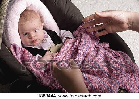 A Parent's Hands Reaching For A Baby In A Carseat View Large Photo Image Picture - A Parent's Hands Reaching For A Baby In A Carseat. Fotosearch