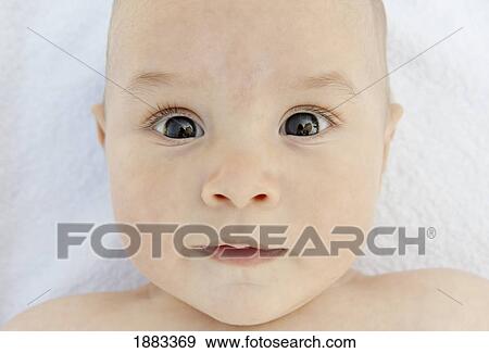 Stock Photo - A Wide Eyed Baby. Fotosearch