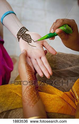 A Woman Doing Henna Painting On Another Woman's Arm; Sathyamangalam, Tamil Nadu, India View Large Photo Image Stock Photograph - A Woman Doing Henna Painting On Another Woman's Arm; Sathyamangalam, Tamil Nadu, India. Fotosearch