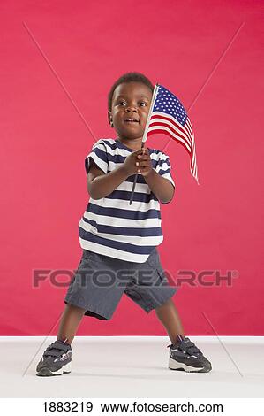 A Young Boy Holding An American Flag View Large Photo Image Stock Photo - A Young Boy Holding An American Flag. Fotosearch