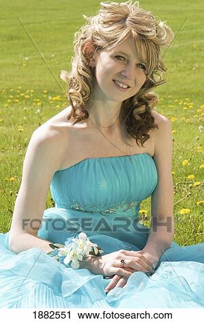 A Young Woman In A Formal Dress Sitting On The Grass; Camrose, Alberta, Canada View Large Photo Image Stock Image - A Young Woman In A Formal Dress Sitting On The Grass; Camrose, Alberta, Canada. Fotosearch