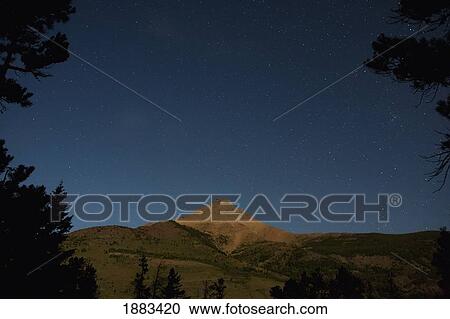 Moon Lit Mountain With Stars In The Sky; Waterton, Alberta, Canada View Large Photo Image Stock Image - Moon Lit Mountain With Stars In The Sky; Waterton, Alberta, Canada. Fotosearch