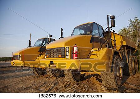 Parked Dump Trucks; Edmonton, Alberta, Canada View Large Photo Image Stock Photograph - Parked Dump Trucks; Edmonton, Alberta, Canada. Fotosearch