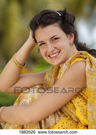 Stock Photograph - Portrait Of A Woman Wearing A Sari And Gold Bangle Bracelets; Sathyamangalam, Tamil Nadu, India. Fotosearch