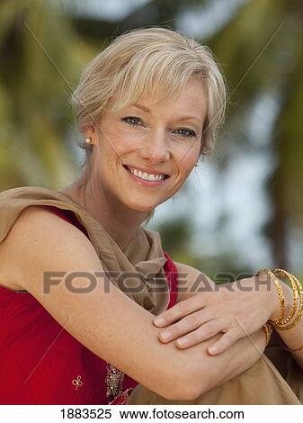 Stock Photography - Portrait Of A Woman Wearing A Sari And Gold Bangle Bracelets; Sathyamangalam, Tamil Nadu, India. Fotosearch